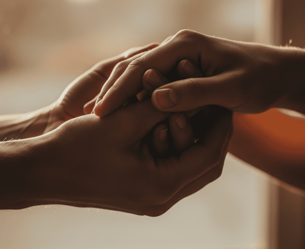 A close-up, compassionate photo of two hands gently holding each other, conveying empathy and support. A close-up, compassionate photo of two hands gently holding each other, conveying empathy and support.