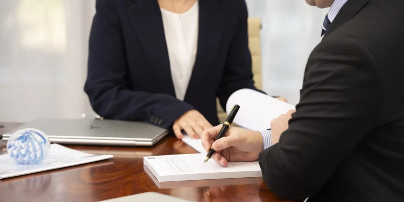 document-with-two-people-min.jpg Two people reviewing legal documents together during a family law consultation in Australia